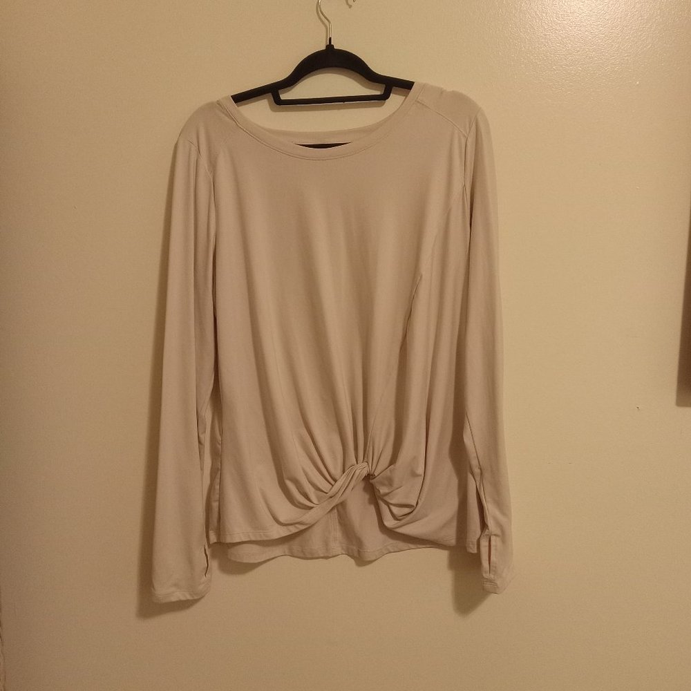 Long-sleeved, cream-colored blouse